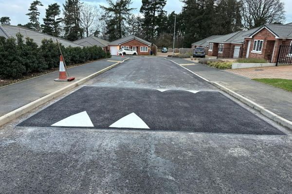 New tarmac estate road with speed table and road markings